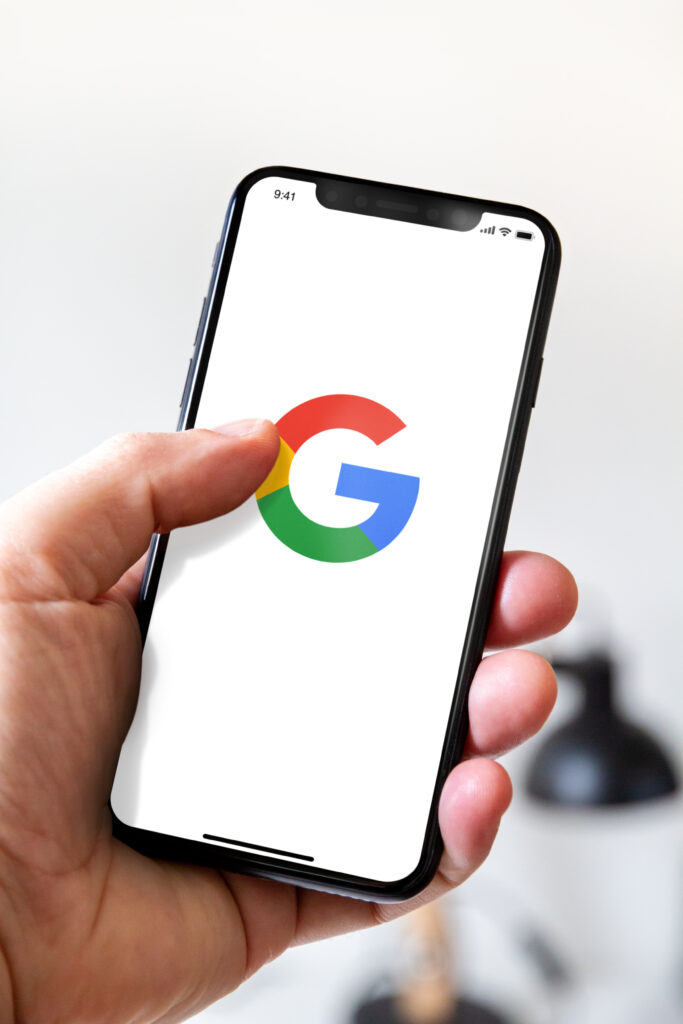 Hand holding iphone smartphone with Google logo, Paris, France